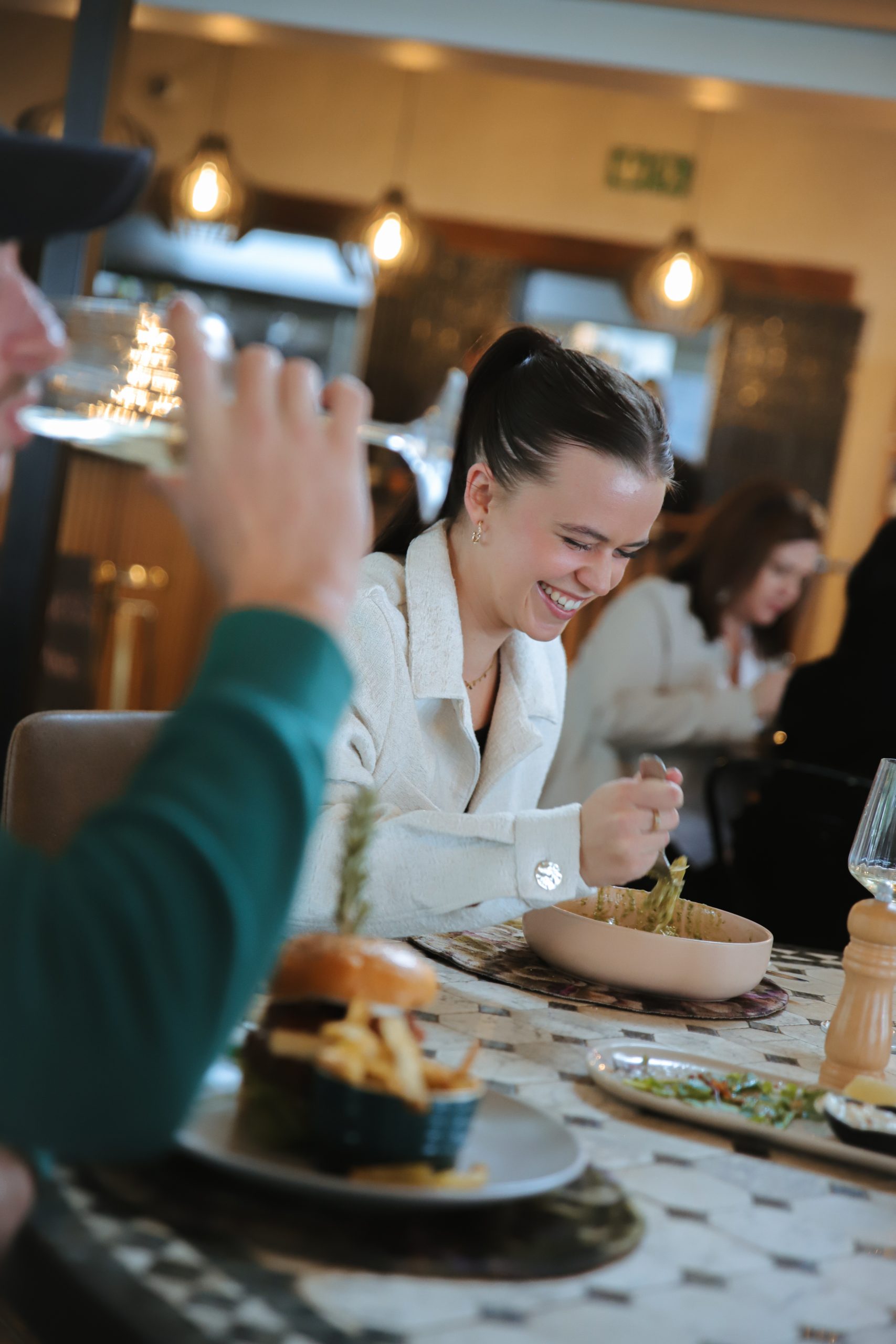 Woman laughing while dining