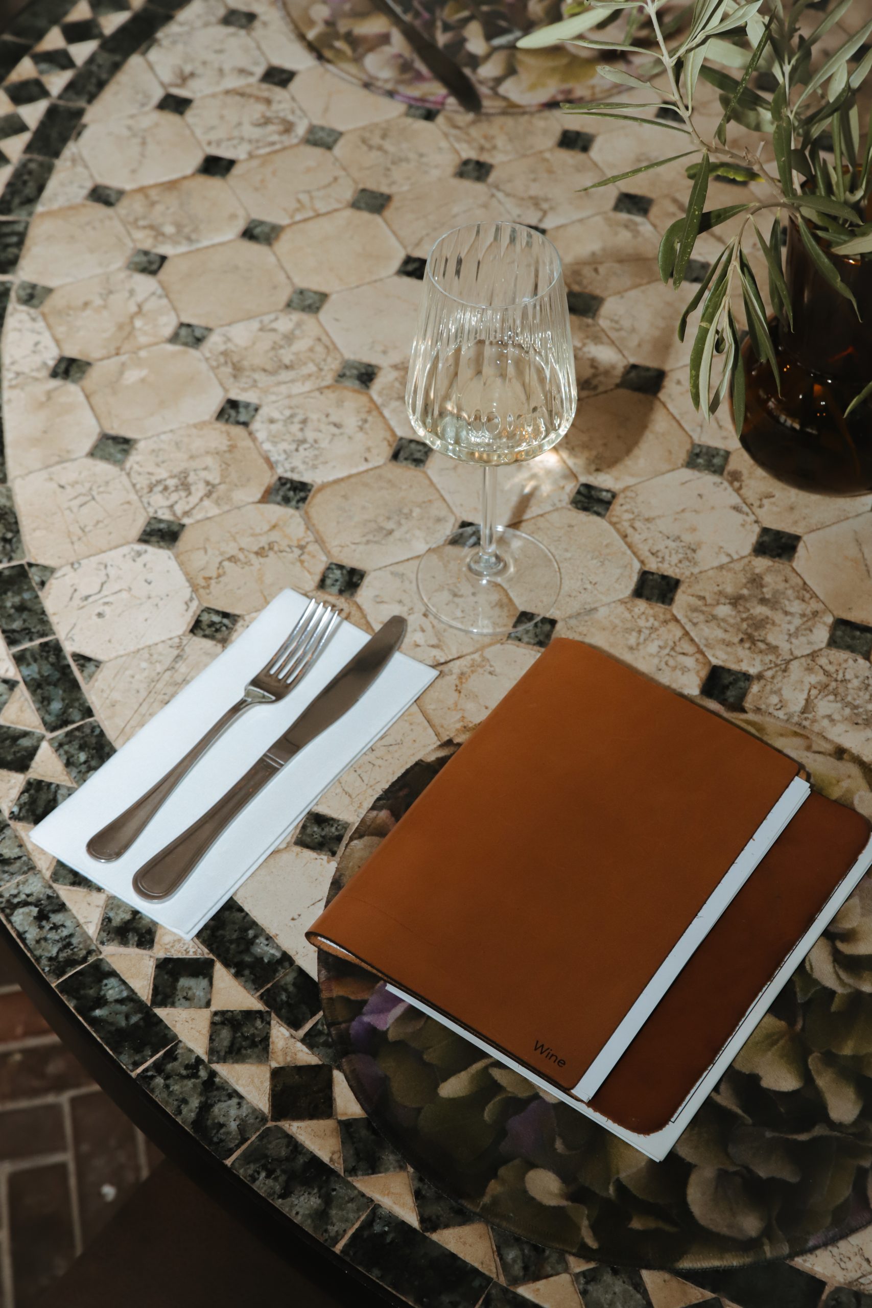 Mosaic table with wine glass and wine menu